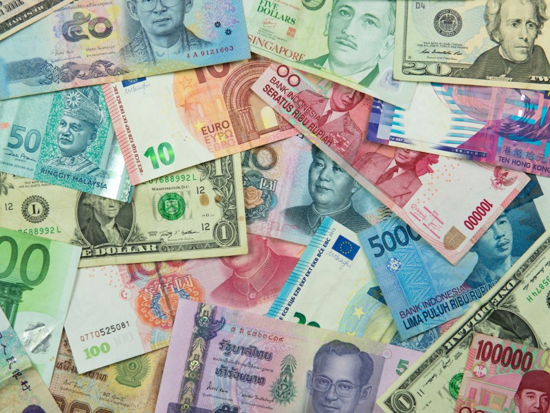 Asian currency banknotes interspersed with US dollars. Photo: iStock/Getty Images.