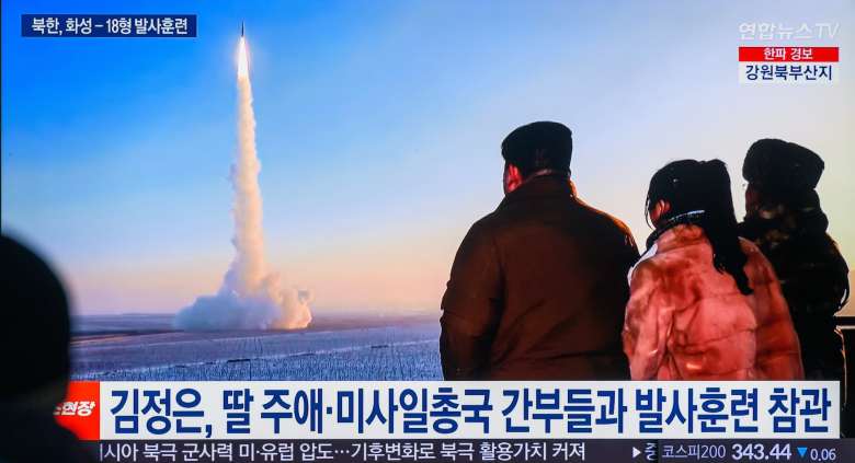 A missile is seen being fired into the air trailed by a plume of smoke.