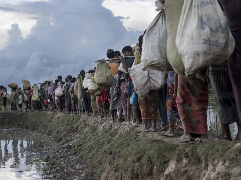 (FILES) In this file photo taken on October 9, 2017 Rohingya refugees walk after crossing the Naf river from Myanmar into Bangladesh in Whaikhyang.Myanmar is continuing its "ethnic cleansing" of the Rohingya with a "campaign of terror and forced starvation" in Rakhine state, a UN human rights envoy said on March 6, 2018, six months after a military crackdown sparked a mass exodus of the Muslim minority. / AFP PHOTO / FRED DUFOUR