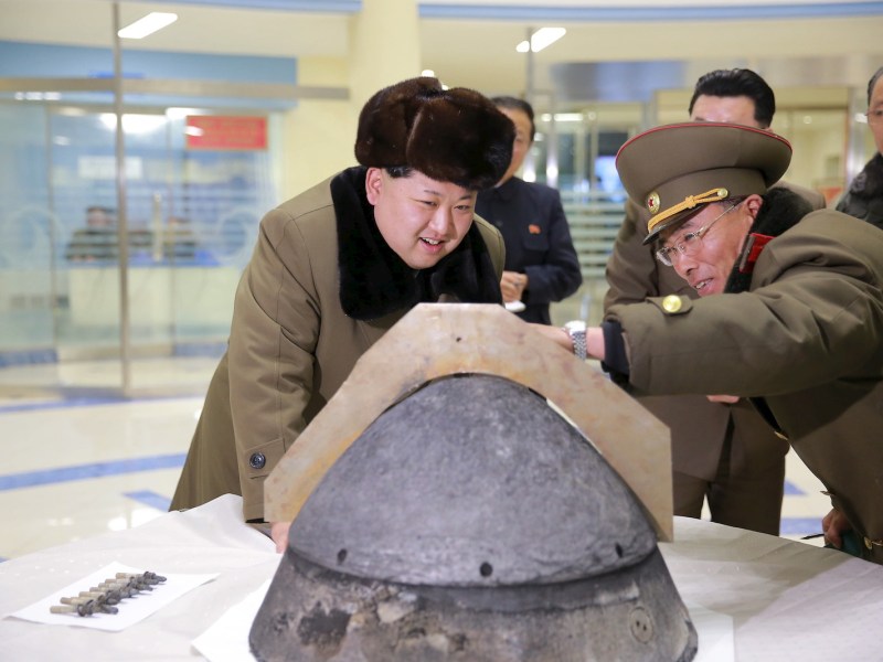 Kim Jong-un looks at a rocket warhead tip after a simulated test of atmospheric re-entry of a ballistic missile, at an unidentified location in this undated photo released March 15, 2016. Photo: Reuters/KCNA