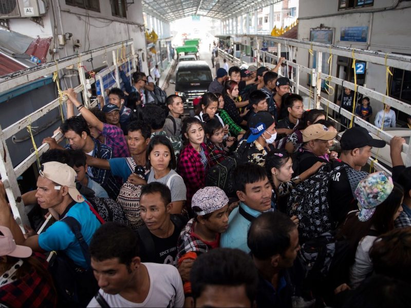Migrant workers pass the Thai-Myanmar border in an official service truck as they left Thailand from Mae Sot, Tak province in northern Thailand. Photo: AFP/Ye Aung PHOTO / Ye Aung Thu